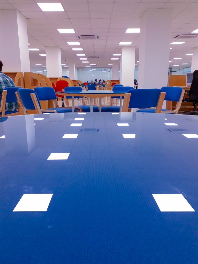 a-blue-table-in-a-large-room-with-blue-chairs-chaznerrana